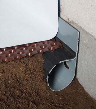 Closeup of a crawl space drainage system installed in Cochranton