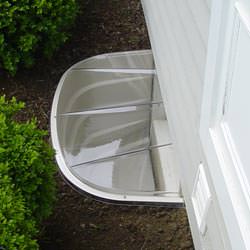 A vinyl basement window and covered window well in Atlantic