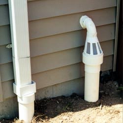 A grated sump pump discharge line fitting in East Springfield