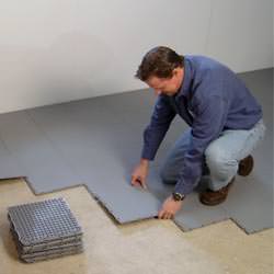 basement subfloor tiles being installed by a contractor in West Springfield