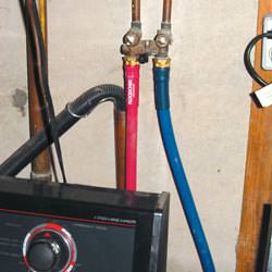 Washer hoses in a basement  in Saegertown